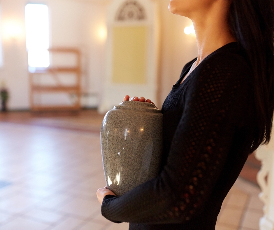 lady holding an urn of a deceased family member